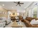 Spacious living room featuring a plush sectional sofa, and large windows overlooking the exterior at 712 Evanvale Ct, Cary, NC 27518