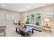 Living room with couch, chairs, area rug, and plenty of light at 712 Evanvale Ct, Cary, NC 27518