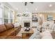 Inviting living room with fireplace, built-ins, and large windows for natural light at 712 Evanvale Ct, Cary, NC 27518