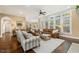 A cozy living room featuring plush seating, a ceiling fan, and large windows at 712 Evanvale Ct, Cary, NC 27518