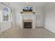 This living room is accented with a stylish fireplace, mantel, and a large sunny window with drapes at 712 Evanvale Ct, Cary, NC 27518