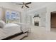 Spacious main bedroom with a fireplace, vaulted ceiling, large windows, and an attached staircase at 712 Evanvale Ct, Cary, NC 27518