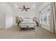 The spacious main bedroom features vaulted ceilings, large windows, and a comfortable, neutral decor at 712 Evanvale Ct, Cary, NC 27518