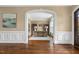 Home office featuring hardwood floors, built-in bookshelves, and arched doorway at 712 Evanvale Ct, Cary, NC 27518