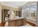 Well-lit office with built-in shelving, a large desk, and a view to the yard at 712 Evanvale Ct, Cary, NC 27518