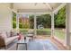 Covered porch features a seating area with views of the landscaped backyard and play area at 712 Evanvale Ct, Cary, NC 27518