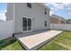 Home features a concrete back patio with sliding glass door to the gray, two-story home at 729 Little Patch St, Zebulon, NC 27597