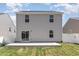 Back exterior view of home with patio and sliding glass door with fenced in yard at 729 Little Patch St, Zebulon, NC 27597