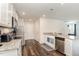 Well-lit kitchen featuring granite countertops, stainless steel appliances, and hardwood-style floors at 729 Little Patch St, Zebulon, NC 27597