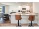 Modern kitchen with granite countertops, stainless steel appliances, and a breakfast bar, ideal for casual dining and food preparation at 729 Little Patch St, Zebulon, NC 27597