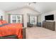 Spacious main bedroom with vaulted ceiling, large windows and stylish decor at 729 Little Patch St, Zebulon, NC 27597