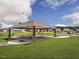 Community pavilion featuring picnic tables, stone pillars, and BBQ grills surrounded by a green lawn at 729 Little Patch St, Zebulon, NC 27597