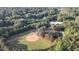 Aerial view of a well-maintained baseball field surrounded by mature trees at 7401 Ray Rd, Raleigh, NC 27613