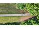 Aerial view of a paved trail lined with lush greenery and open fields at 7401 Ray Rd, Raleigh, NC 27613