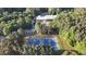 Aerial shot of tennis courts nestled in a lush, green forest at 7401 Ray Rd, Raleigh, NC 27613