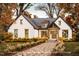 Charming white brick home with a welcoming front entrance and well-manicured landscaping at 7401 Ray Rd, Raleigh, NC 27613