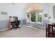 Bright bedroom with a large arched window, desk, and stylish decor at 7508 Venture Ct, Raleigh, NC 27615