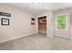 Neutral bedroom with built-in shelving/desk and natural light at 7508 Venture Ct, Raleigh, NC 27615