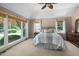 Bright primary bedroom boasting ample natural light from large windows and neutral decor at 7508 Venture Ct, Raleigh, NC 27615