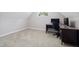 Simple bedroom with a desk, large window, and a neutral color scheme at 7508 Venture Ct, Raleigh, NC 27615