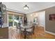 Dining room with a glass table, ornate chairs, and a large window at 7508 Venture Ct, Raleigh, NC 27615