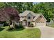 Traditional brick home with manicured front lawn, mature trees and driveway at 7508 Venture Ct, Raleigh, NC 27615