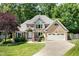 Charming two-story brick home with a well-manicured lawn and attached two-car garage at 7508 Venture Ct, Raleigh, NC 27615