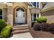 Elegant front entrance with a white door and brick facade at 7508 Venture Ct, Raleigh, NC 27615