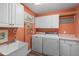 Functional laundry room equipped with a washer, dryer, sink, and built-in cabinets at 7508 Venture Ct, Raleigh, NC 27615