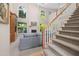 Spacious living room with large windows, fireplace, and staircase to upper level at 7508 Venture Ct, Raleigh, NC 27615