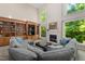 Cozy living room featuring a fireplace, built-in bookshelves, and a comfortable sectional sofa at 7508 Venture Ct, Raleigh, NC 27615
