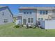 Backyard featuring a well-maintained lawn, seating area, and privacy fence at 79 Hawkstone Dr, Clayton, NC 27527