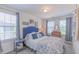 Cozy bedroom featuring two bright windows, a comfortable bed, and a dresser at 79 Hawkstone Dr, Clayton, NC 27527