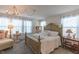 Elegant bedroom featuring a decorative chandelier, neutral walls, and a detailed, light wood bed frame at 79 Hawkstone Dr, Clayton, NC 27527