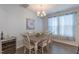 Cozy dining area featuring a rustic wooden table, chairs, and natural light at 79 Hawkstone Dr, Clayton, NC 27527