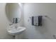 Simple half bathroom features a pedestal sink, a modern mirror, and elegant towel rack at 79 Hawkstone Dr, Clayton, NC 27527