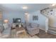 Spacious living room with natural light, comfortable seating, and seamless flow into the adjacent rooms at 79 Hawkstone Dr, Clayton, NC 27527