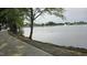 Picturesque pond view with a walking trail, trees, and a fountain in the distance at 79 Hawkstone Dr, Clayton, NC 27527