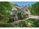 The back of a house is surrounded by trees and has a screened in porch at 800 Oxbow Crossing Rd, Chapel Hill, NC 27516