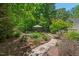 Tranquil backyard garden featuring stone paths and meticulously arranged greenery, offering a peaceful retreat at 800 Oxbow Crossing Rd, Chapel Hill, NC 27516