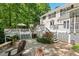 Backyard with a stone patio, fire pit, and deck with seating, ideal for outdoor enjoyment at 800 Oxbow Crossing Rd, Chapel Hill, NC 27516
