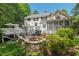 Spacious backyard with a stone fire pit, deck, and lush landscaping, great for entertaining at 800 Oxbow Crossing Rd, Chapel Hill, NC 27516