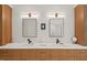 Elegant bathroom featuring double sinks, wood-tone cabinetry, and neutral color scheme at 800 Oxbow Crossing Rd, Chapel Hill, NC 27516