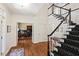 Grand foyer with hardwood floors, staircase, and view into office with french doors at 800 Oxbow Crossing Rd, Chapel Hill, NC 27516