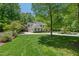 A well-manicured front yard with lush green lawn and mature trees at 800 Oxbow Crossing Rd, Chapel Hill, NC 27516