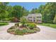 Beautiful landscaped circular driveway with mature plantings surrounding this traditional two story home at 800 Oxbow Crossing Rd, Chapel Hill, NC 27516
