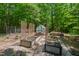 Backyard garden area with planting beds and greenhouse in private, wooded setting at 800 Oxbow Crossing Rd, Chapel Hill, NC 27516