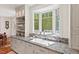 Bright kitchen with granite countertops, bay window, white cabinetry and open shelving at 800 Oxbow Crossing Rd, Chapel Hill, NC 27516
