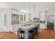 Bright kitchen featuring white cabinets, granite countertops, a spacious island, and wood floors at 800 Oxbow Crossing Rd, Chapel Hill, NC 27516