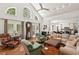 Spacious living room with tall windows, hardwood floors, and an open layout to the kitchen at 800 Oxbow Crossing Rd, Chapel Hill, NC 27516